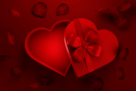 Heart shaped gift box with rose petals flying on red background. Valentine present for premium product placement. Holiday sale giftbox.の写真素材
