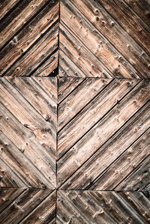 Geometric abstract closeup of natural aged and rural rustic wood surface of recycled weathered planks constructed in creative, decorative lines, old vintage wooden background or backdrop with space for text.の写真素材