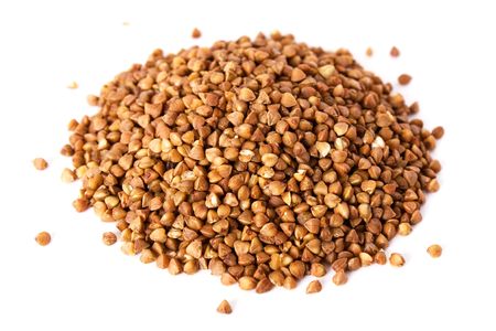 Hill of Buckwheat groats isolated on whiteの写真素材