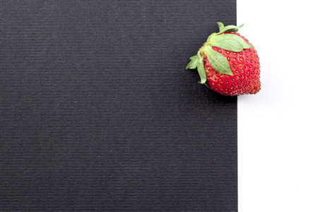 a strawberry on a black and white backgroundの写真素材