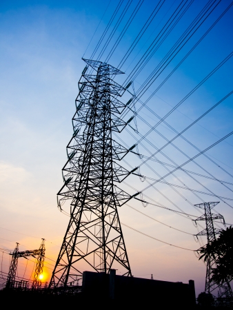 High-voltage tower on sun set sky background.の写真素材