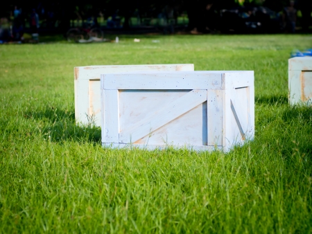 wooden crates in garden on green grassの写真素材
