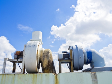 aged metal chimney on the terrace with blue sky backgroundの写真素材