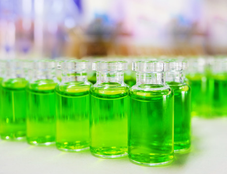 green chemical substance samples on the test bottlesの写真素材