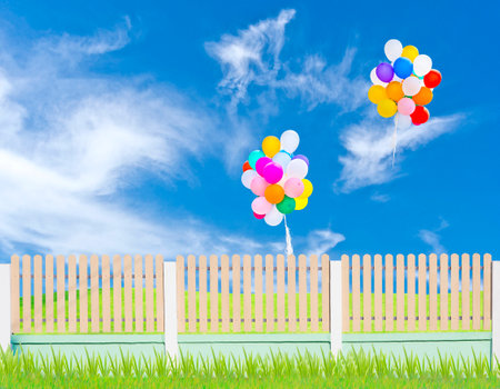 fence and balloons on blue skyの写真素材