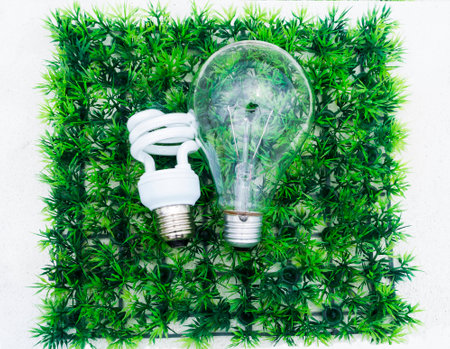 light bulb in different size on artificial green grassの写真素材
