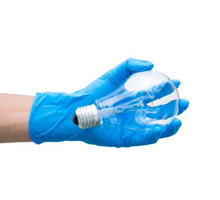 light bulb on hand isolated on white の写真素材