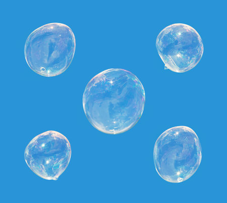 five soap bubbles isolated on blue の写真素材