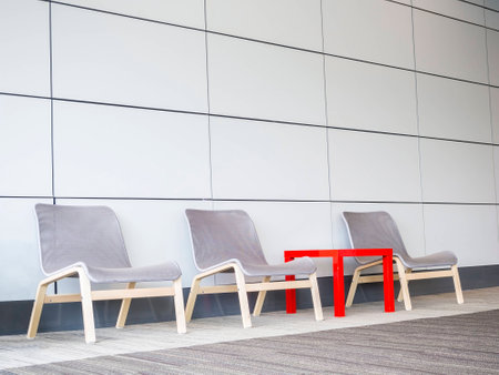chairs and small table on floor beside the modern wall, minimal conceptの写真素材