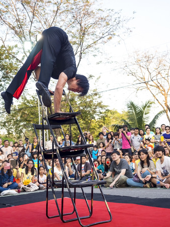 BANGKOK, THAILAND - DECEMBER 14, 2014: Performer show the balance ability by his arm in Bangkok street show 2014, hold in Lumpini Park, Bangkok , Thailandのeditorial素材