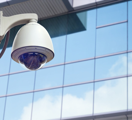 cctv installed outdoor in front of the building on the colorful night