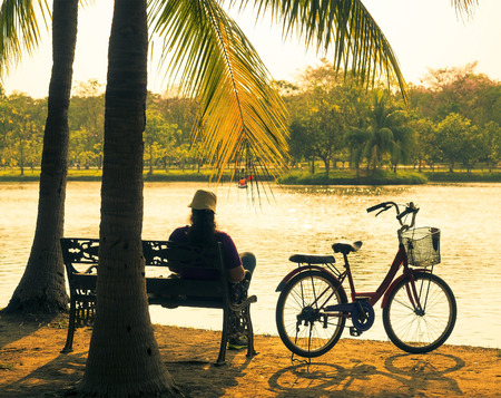 bicycle on the grass with sun set background, vintage styleの写真素材