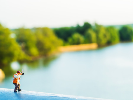 lovely plastic toy standing outdoor to take photos with riverside backgroundの写真素材