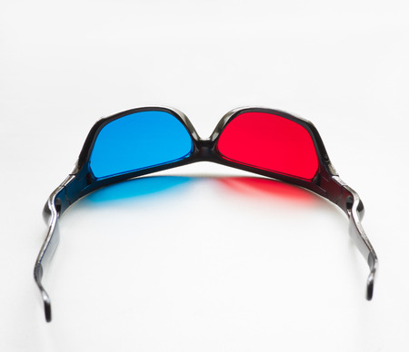 red and blue on stereo glasses for three dimensional movie on white backgroundの写真素材