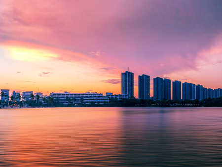 colorful sunset sky in the city reflecting on the water surfaceの写真素材