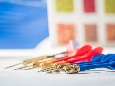 Business concept with darts pointing to the same target, selective focused