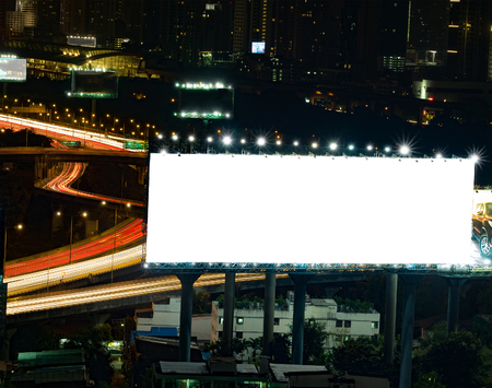 blank billboard in the night time for advertisement. long exposure makes long street light tails.の写真素材