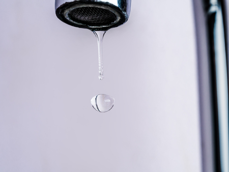 close up shot on water drop from faucet in stop motion