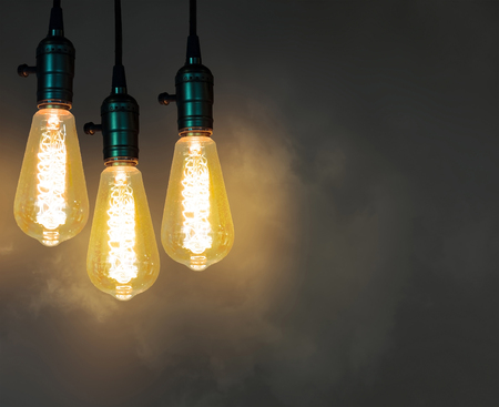 vintage incandescent light bulb on service hanging on the ceilingの写真素材