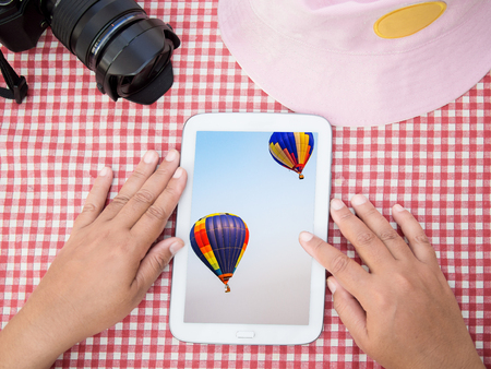 hot air balloon airship in journey display on tablet equipmentの写真素材
