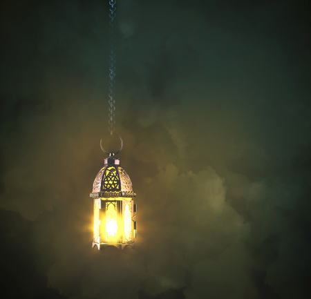 lantern lamp hanging on metal chains on the dark with cloud backgroundの写真素材