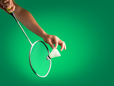 badminton sport in service action, racket with string and shuttlecock on player's handsの写真素材