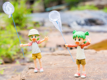 BANGKOK, Thailand - July 30, 2016 : Yotsuba anime figure placed on outdoor nature with net on hand. Yotsuba models are also popular in asia.のeditorial素材