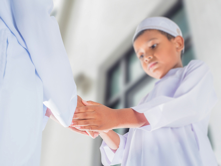 boys make greeting by Muslim style handshake in ceremony events, EID MUBARAK