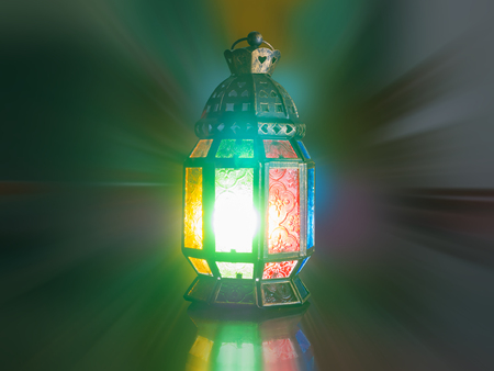 lighting with candle inside Lantern shining on the dark, children play with it in Ramadan night, also known and called as Ramadan Kareem Lanternの写真素材