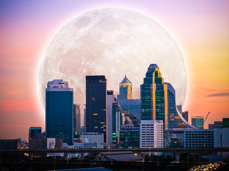 city downtown in the sunset time with full moon, element of this image furnished by NASAの写真素材