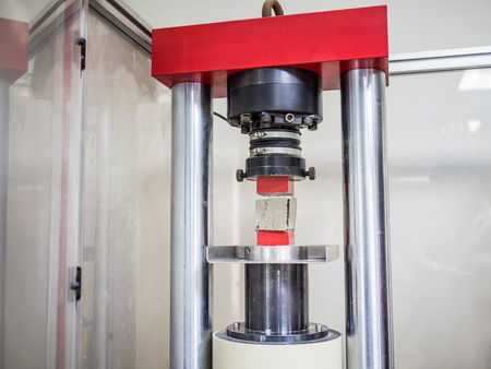 physical testing machine in engineering laboratory with load cell to calculated compressive strength...