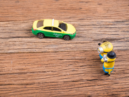 BANGKOK, THAILAND - MARCH 27, 2017: Minions toy figures on wooden background, Minion is a figure from Despicable Me and Minions(2015)  produced by Illumination Entertainment for Universal Pictures.のeditorial素材