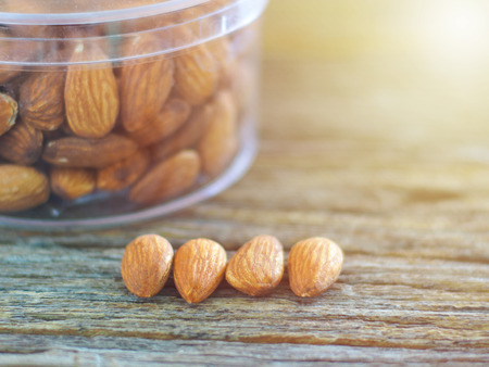 created shot of almonds on wooden background in small dept of fieldの写真素材