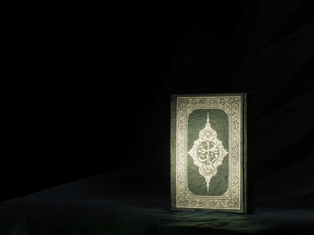 Quran or Kuran, the islamic holy book, in dark backgroundの写真素材