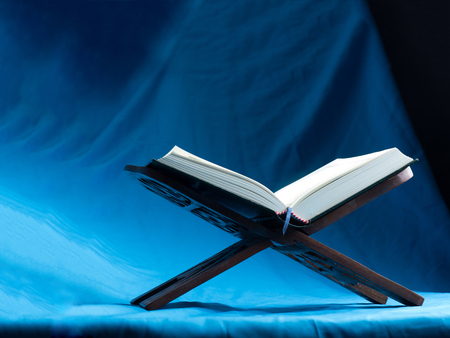 Quran or Kuran, the islamic holy book, in dark backgroundの写真素材