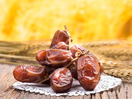 close up shot on dates, sweet dried fruits on wooden background,  vegetable for diet with nutrition ingredient concept.の写真素材