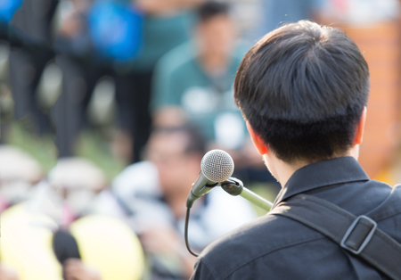 dynamic microphone in use by people to send massage or entertain audienceの写真素材