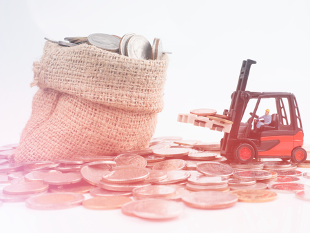 folklift and money metal coins on bag, business conceptの写真素材