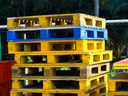 stack of colorful wooden pallets used in industrial logisticsの写真素材
