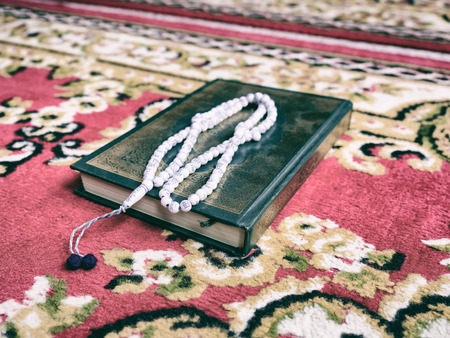Muslim woman with fully traditional dress praying for Allah, Muslim God, on mosque in ramadan kareem monthの写真素材