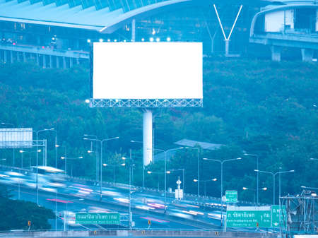 blank white bilboard on tower and on dark city backgroundの写真素材