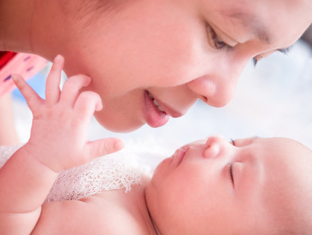 cute baby newborn in lovely action, motherhood conceptの写真素材