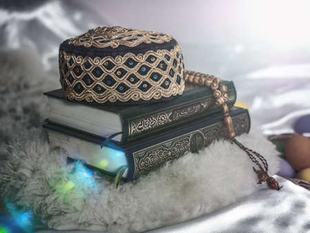 Quran or Kuran ( the islamic holy book) on white background with rosary bead ready to read in...