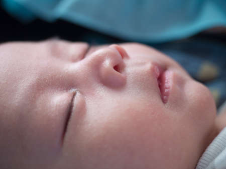 cute baby newborn in lovely action, motherhood conceptの写真素材