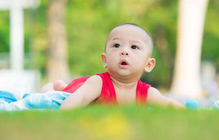 cute asian six-month baby in traditional dress smiling with his mother chinese newyear festival. Happy motherhood concept.の写真素材