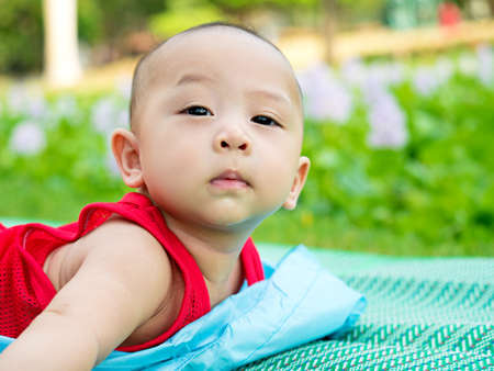 cute asian six-month baby in traditional dress smiling with his mother chinese newyear festival. Happy motherhood concept.の写真素材