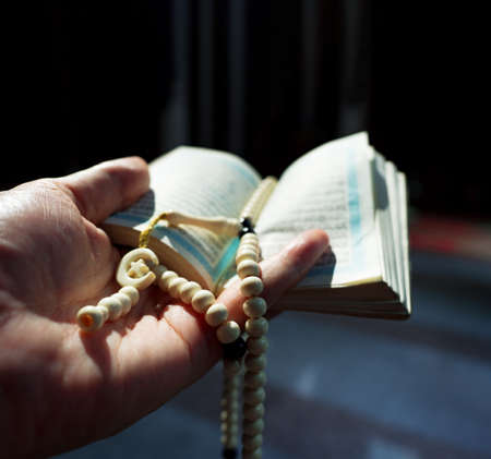Quran or Kuran ( the islamic holy book) on black background with rosary bead ready to read in ramadan night, muslim style and ramadan conceptの写真素材