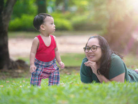 Close up shot of cute asian baby in lovely actions in the outdoor nature, health care and motherhood concept.の写真素材