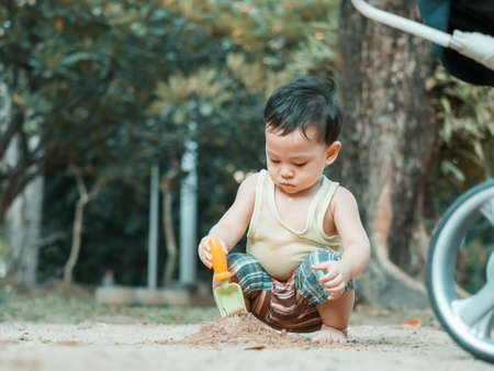 Close up shot of cute asian baby in playing actions in the outdoorsand playground, health care and motherhood concept.の写真素材