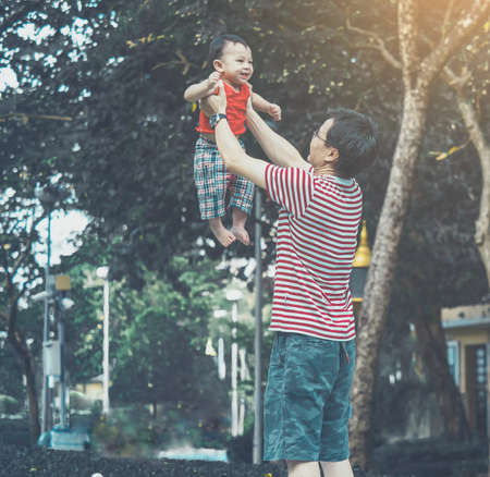 Close up shot of cute asian baby in lovely actions in the outdoor nature, health care and fatherhood...